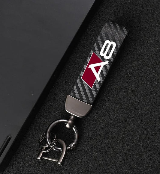 Suitable for Audi Q3 car keychains, horseshoe buckles, carbon fiber leather, black and red